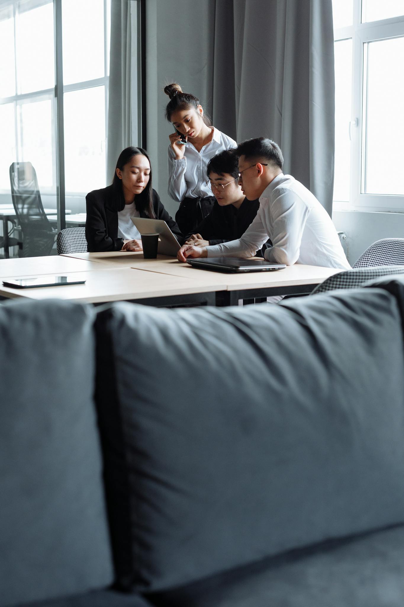 A diverse group of colleagues brainstorming together in a modern office setting.